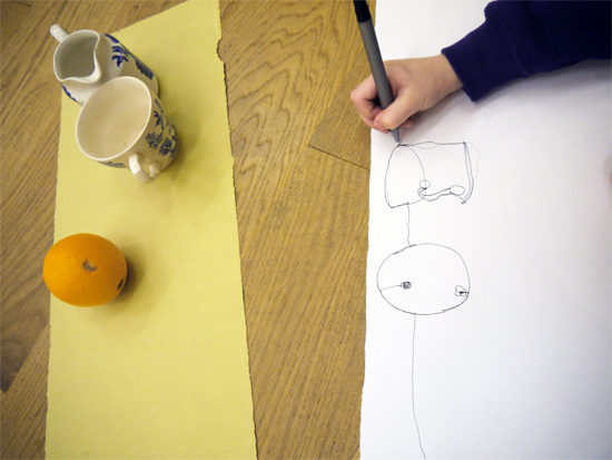 In the first of a three part workshop on painting a still life, children gain familiarity with the objects by making continuous line drawings. As well as tuning into the subject matter, the drawing exercises also encourage the children to consider the shape and dimensions of the canvases right from the start.