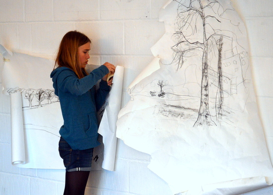 student puts windy drawing on the wall at artworks