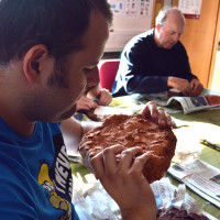 Student examines his work and looks at the detail captured by the clay