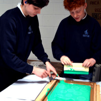 Boys get to work! Andy encourages experimenation and working by trial and error to explore screen printing