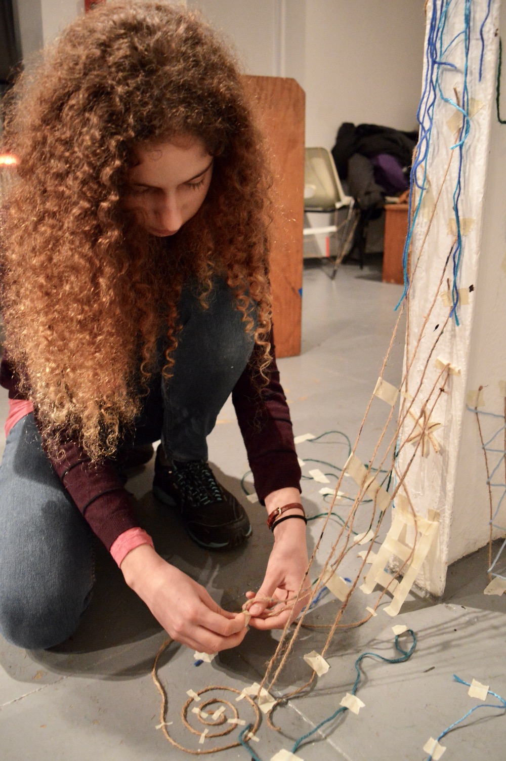 teenager, Esther, working on installation with artist Melissa Murray