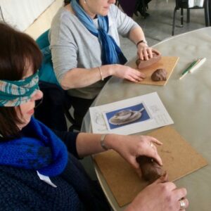 A teacher explores clay through touch - Linda Green