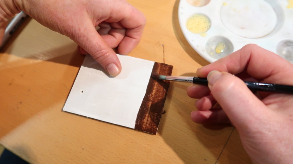 Using the egg to bind the pigment to a pre-prepared plywood piece