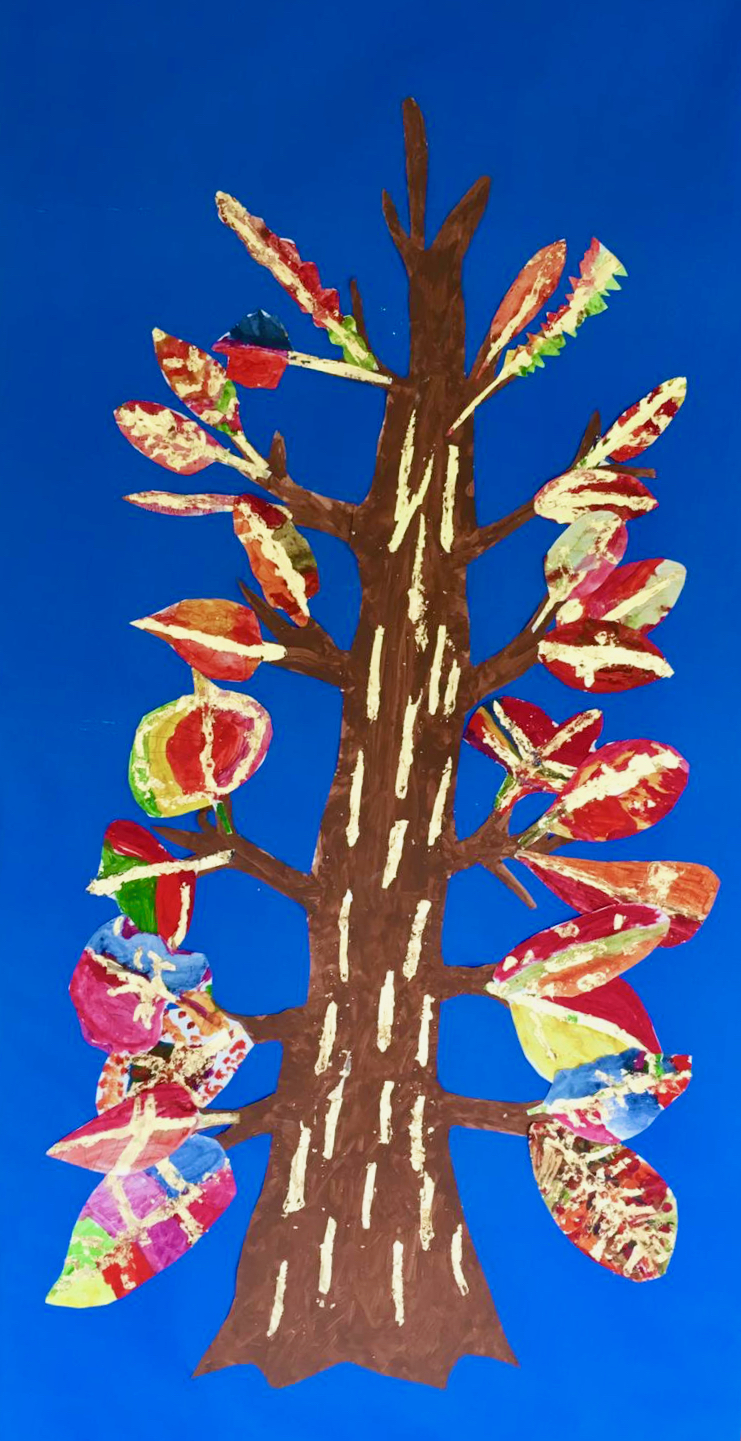 A tall, thin symmetrical tree with fifteen, large leaves down one side and mirrored with fifteen on the other. The leaves are brightly coloured and have gold leaf enhancements. The tree is on a bright blue background with a brown trunk