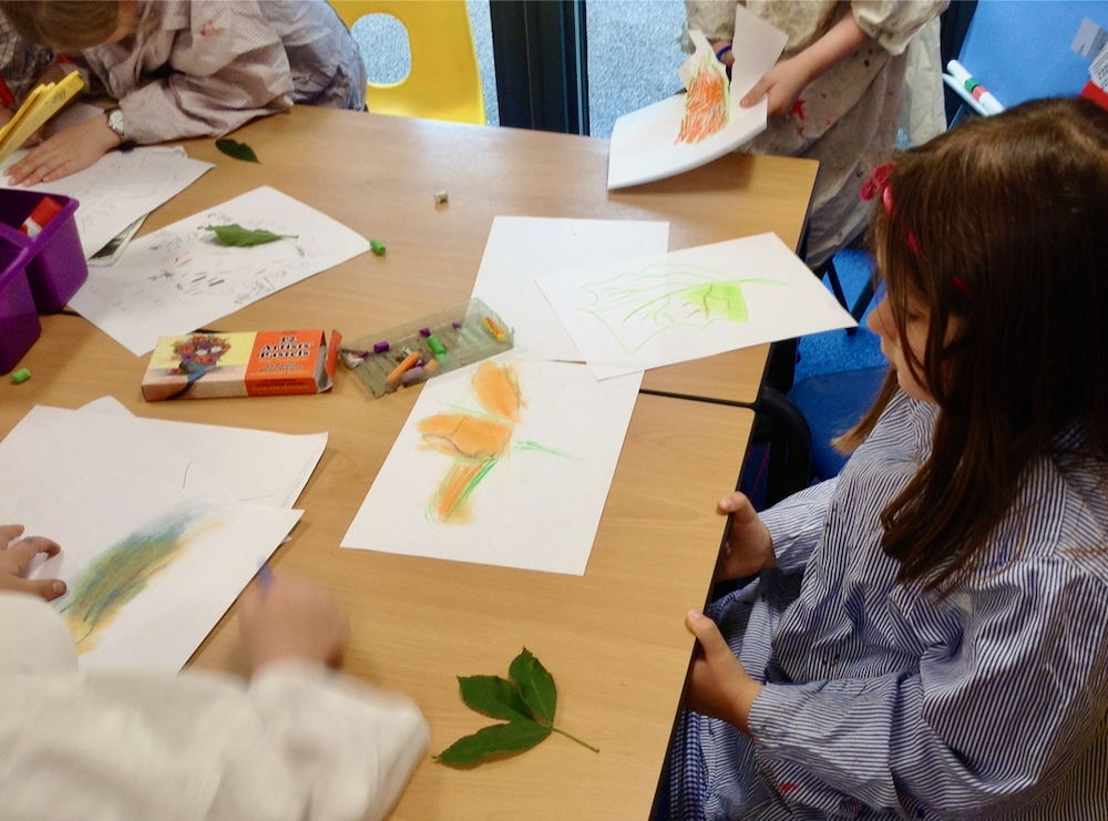 Year Two Girl at Hauxton Primary School drawing leaves with pastels with Pamela Stewart for Inspire