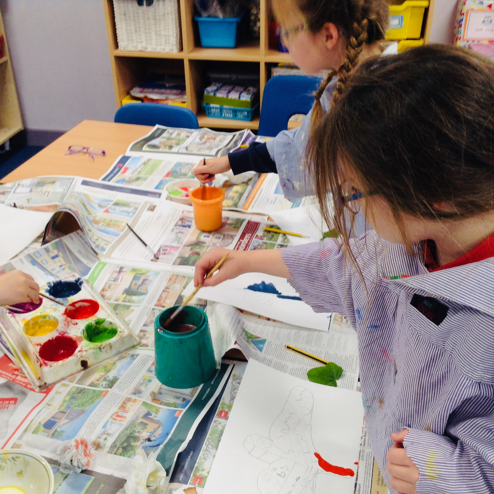 A Year Two girl mixes paints for a colourful leaf with egg tempera mixing powder paint and egg at Hauxton Primary for Inspire with Pamela Stewart 
