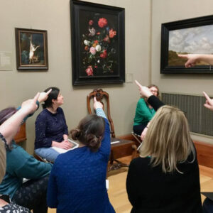 Teachers pointing at flowers in a glass vase by de Heem at the Fitzwilliam Museum, Cambridge