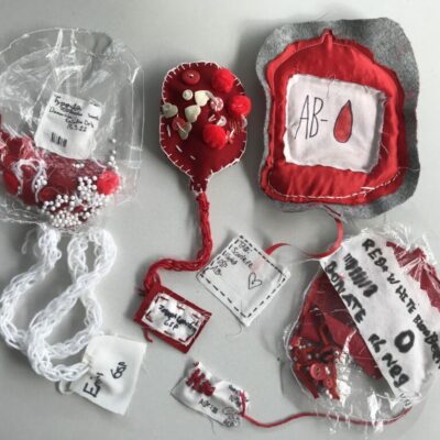 Four textile blood bags on display by Mandy Barrett