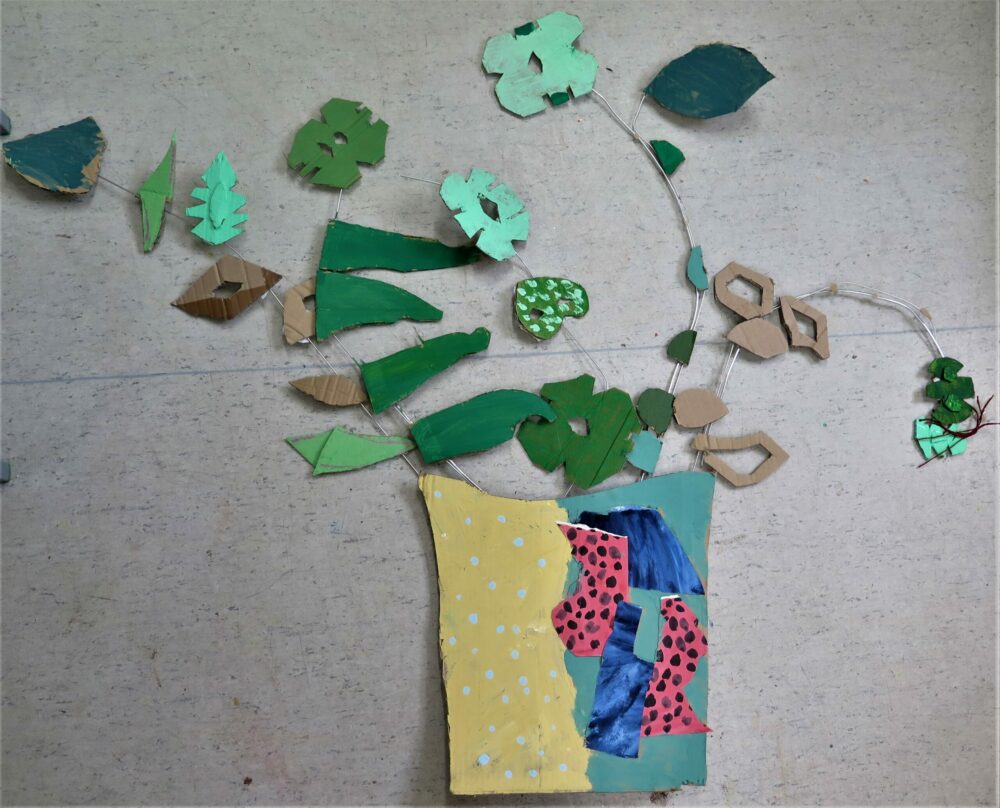 Using scrap card to make a plant pot collage.