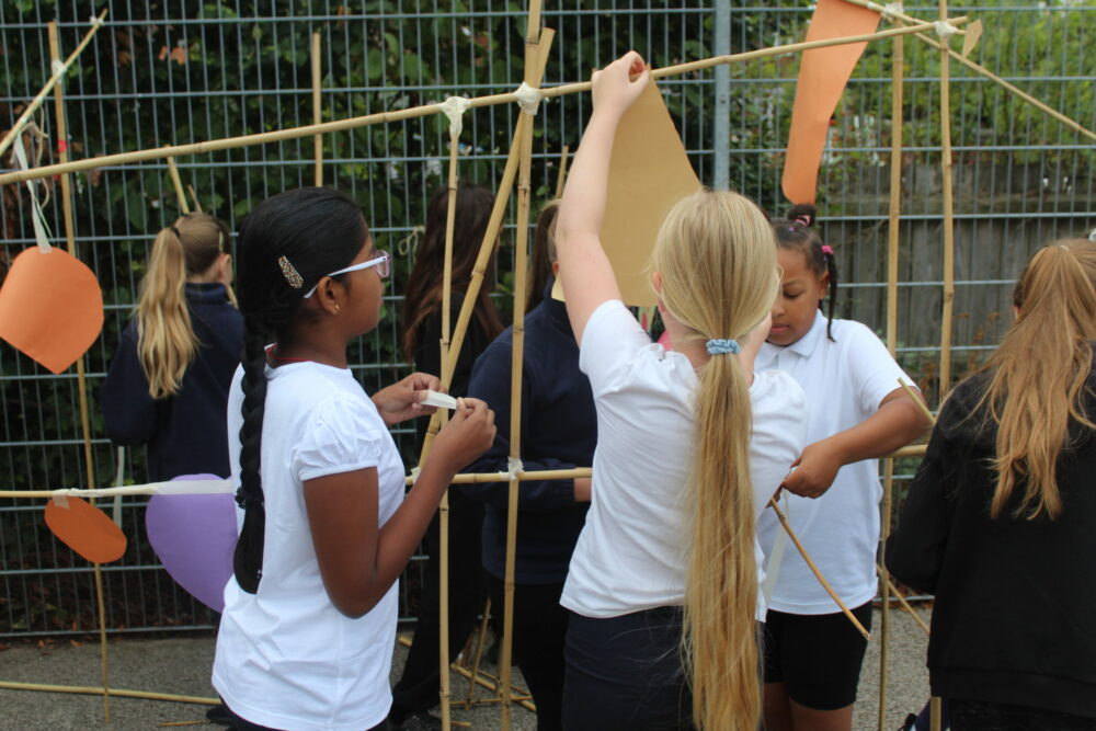 Hanging shapes to a large line made from bamboo canes