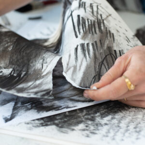 Make expressive marks using charcoal, in order to create a collage of a coal mine scene.