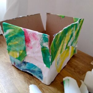 A box covered in painted paper.