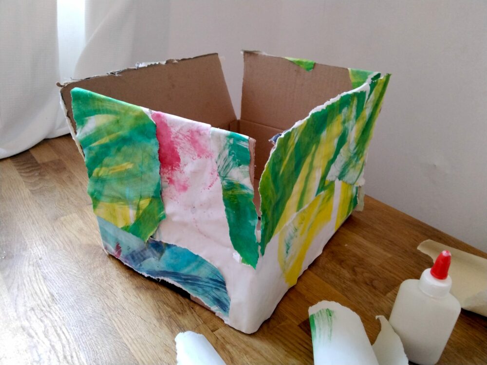A box covered in painted paper.