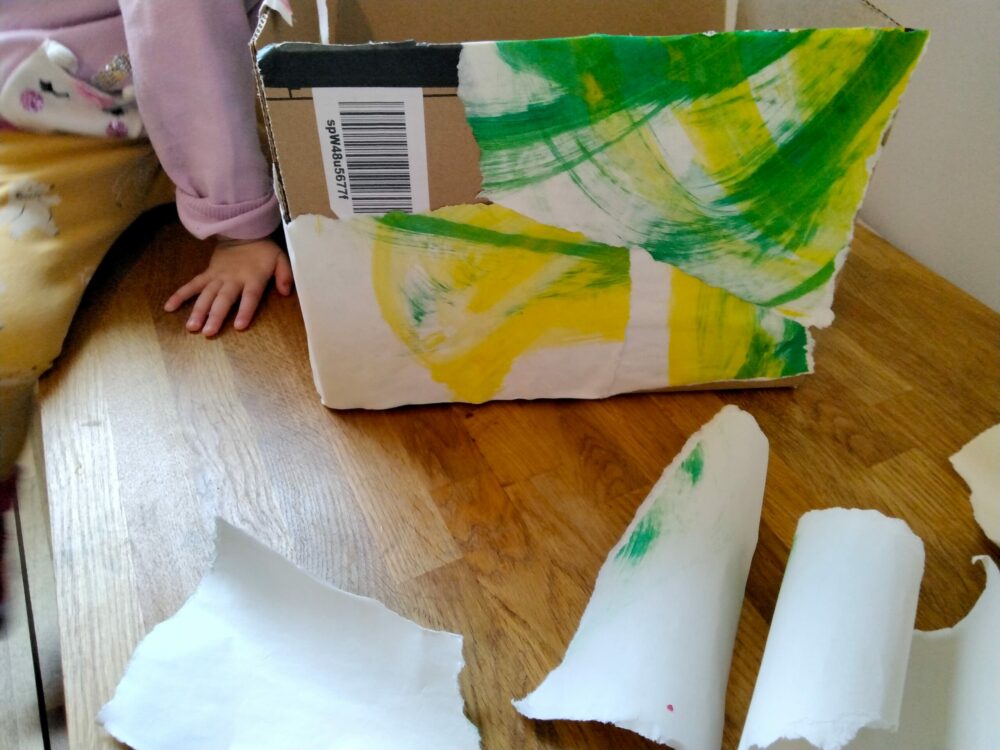 Glueing paper onto a box.