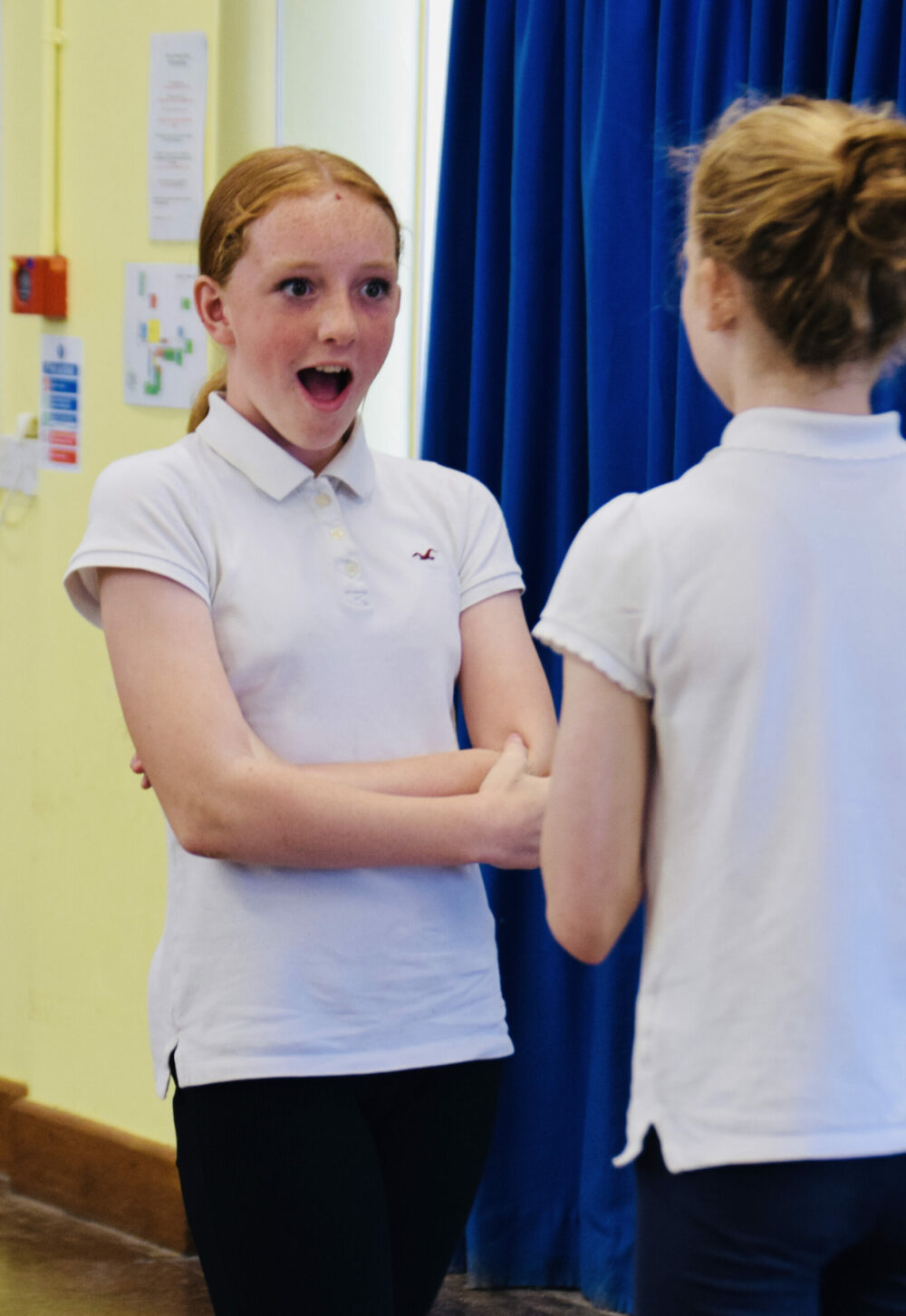 Two school children doing a drama role play activity.
