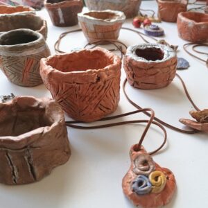 Clay pots and pendant necklaces by Charlotte Puddephatt